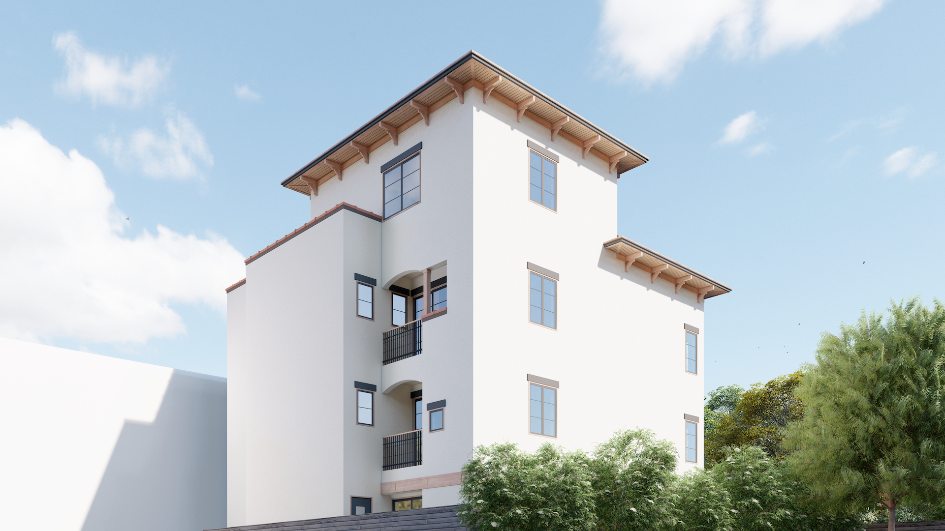 Three-story white residential building with multiple windows, balconies, and a wooden roof overhang against a blue sky with clouds.
