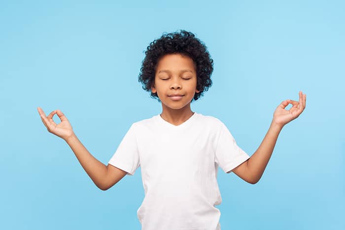 smiling young boy on a blue background