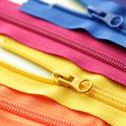 A orange, yellow, pink and blue coiled zipper needed to for TaF.tc's Intermediate Drafting and Sewing class! 