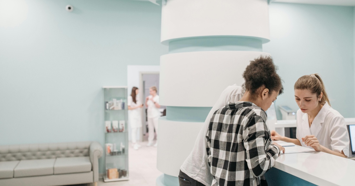 surgery receptionist helping patients