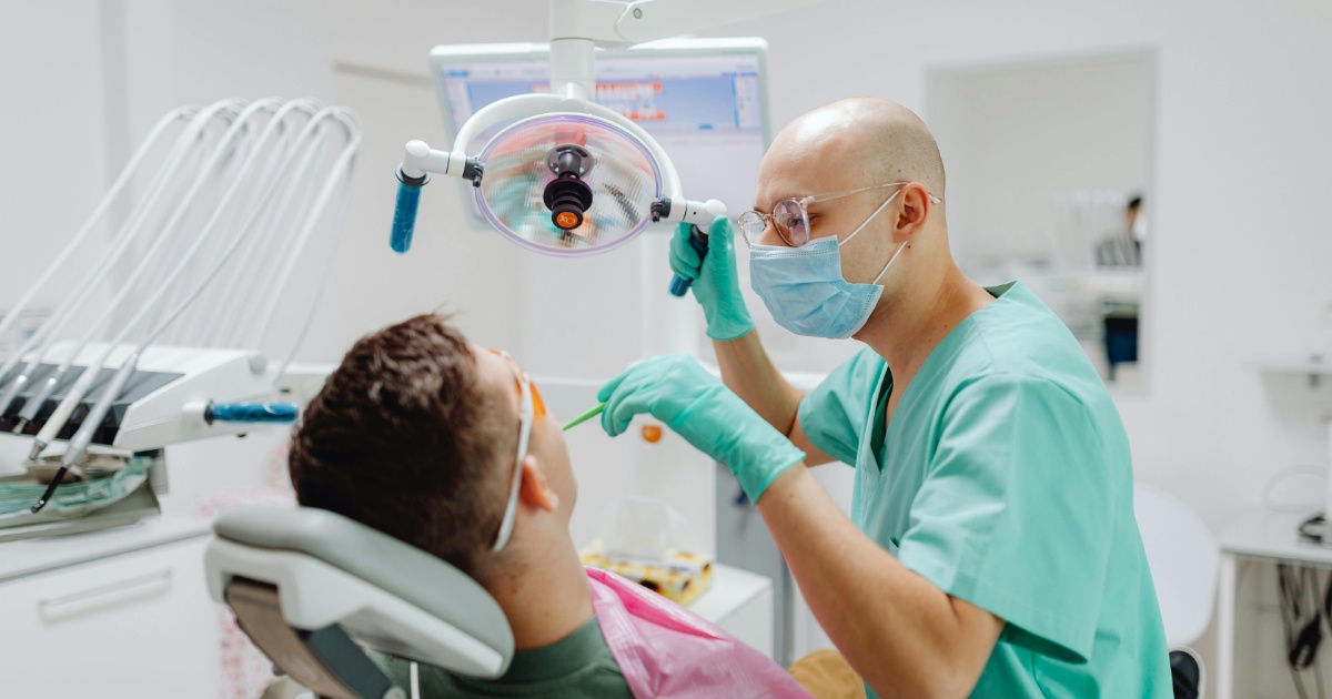dentist speaking to patient in dentist chair