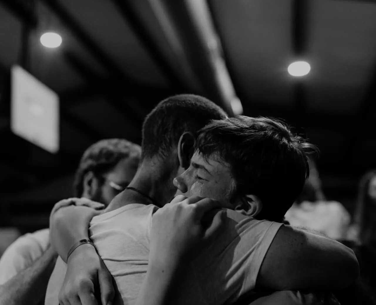 little boy crying and embraced by a man at First Baptist Church- Indian Trail