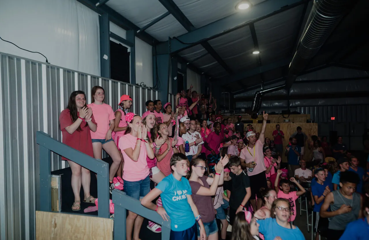 group of people with pink shirts cheering at First Baptist Church- Indian Trail