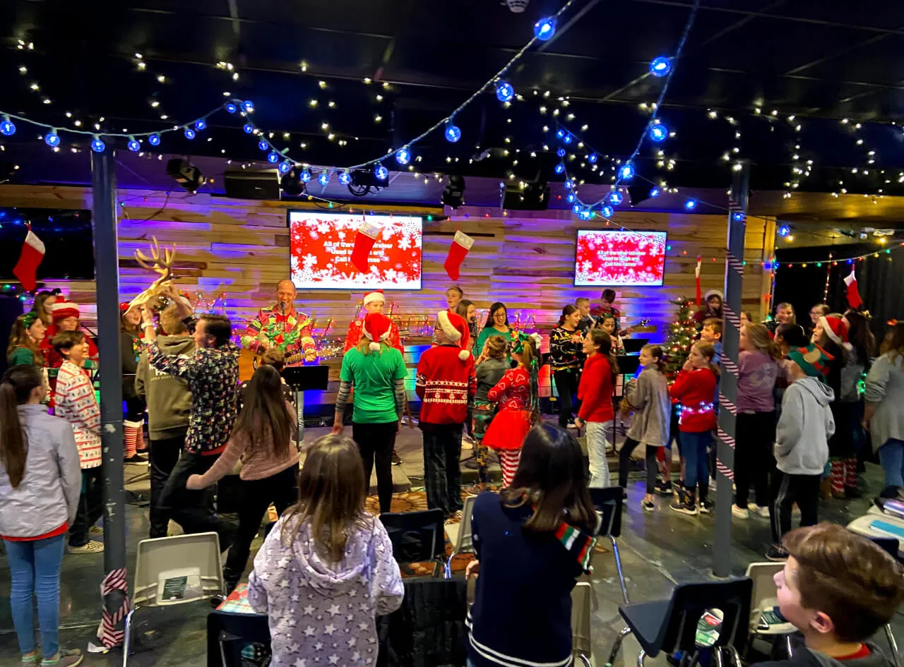 people singing with Christmas hat and attires at First Baptist Church- Indian Trail