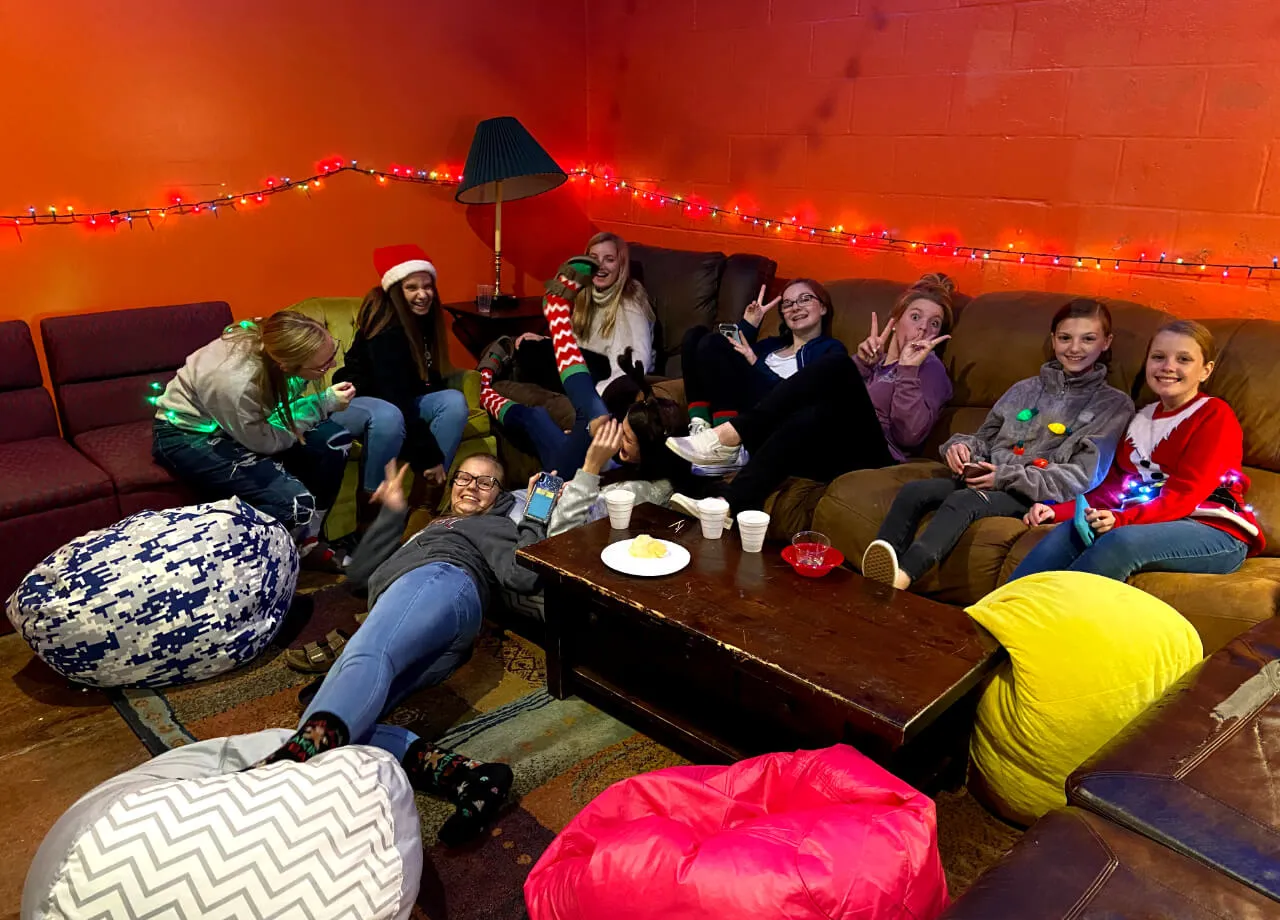 group of girls on the sofa with Christmas lights decoration at First Baptist Church- Indian Trail
