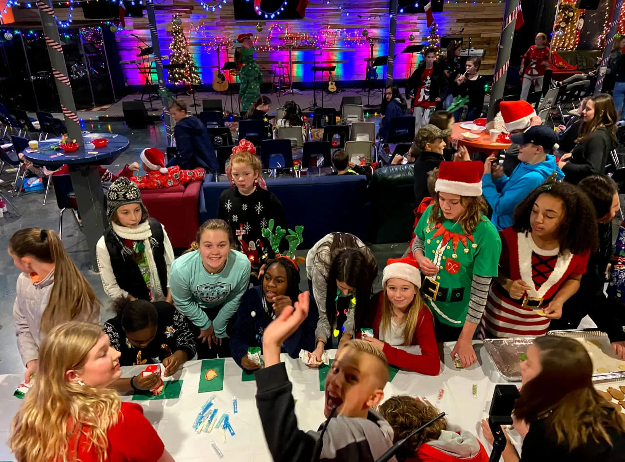group of kids baking cookies with Christmas attires at First Baptist Church- Indian Trail