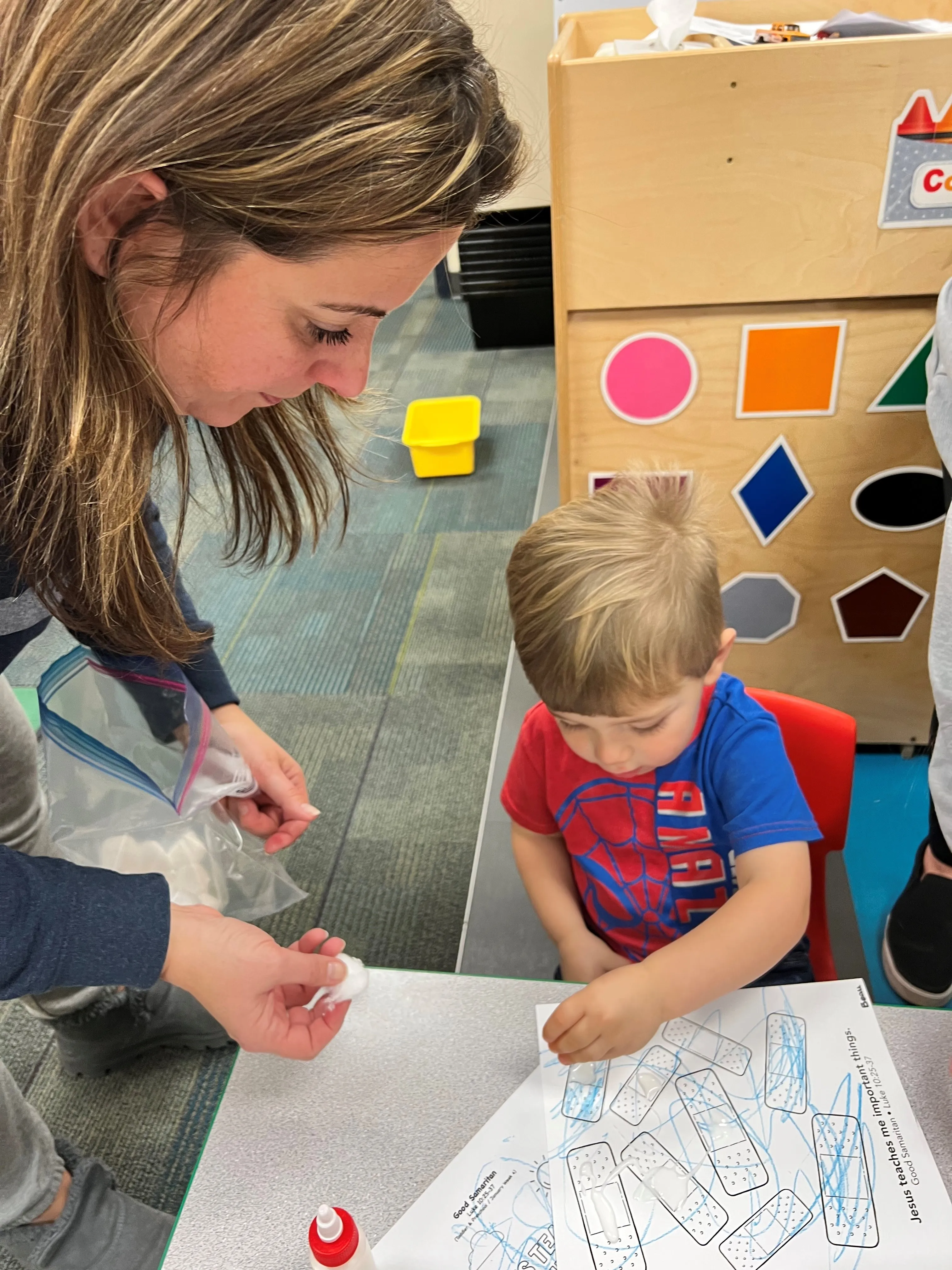teaching little boy how to color at First Baptist Church- Indian Trail