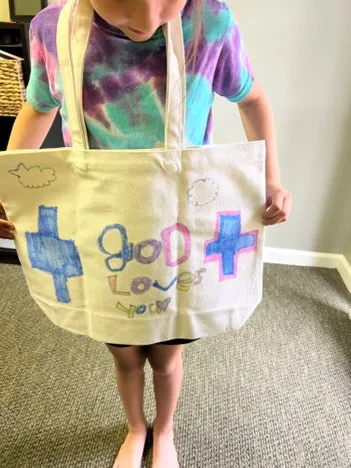 Little boy holding god loves you at First Baptist Church Indian Trail.