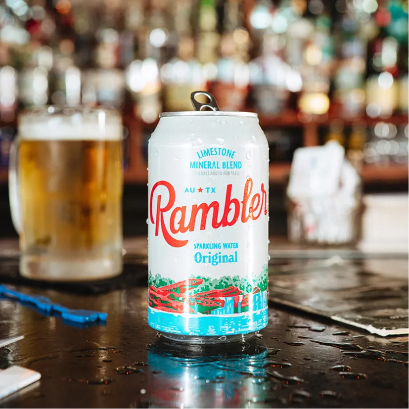 Rambler Sparkling Water Original flavor can on a bar top.