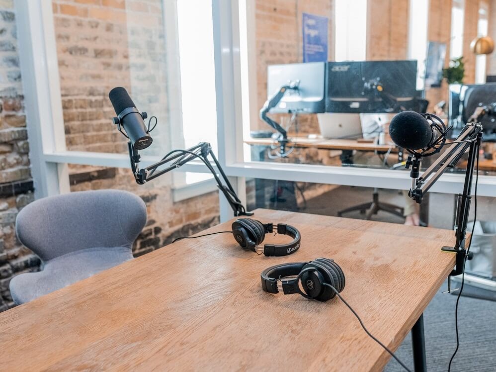 Studio with podcast equipment including microphones and headphones.