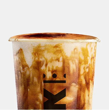 Krak Boba brown sugar milk tea topped with creamy foam in a branded cup.
