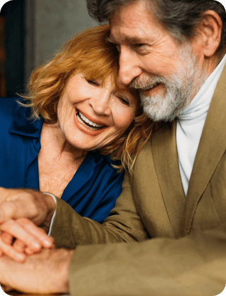 A couple hugging and laughing.