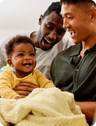 A couple holding a baby.