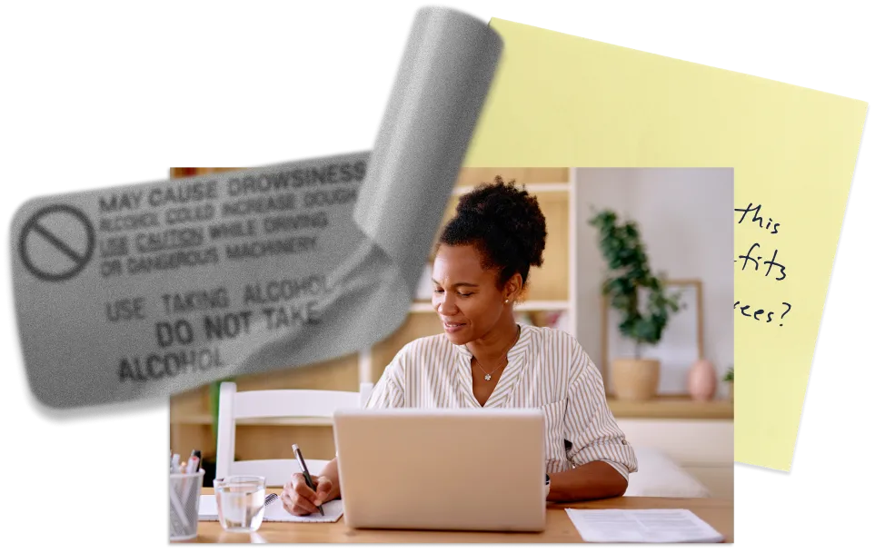 Woman working on a laptop at home, next to a sticky note and a medication label