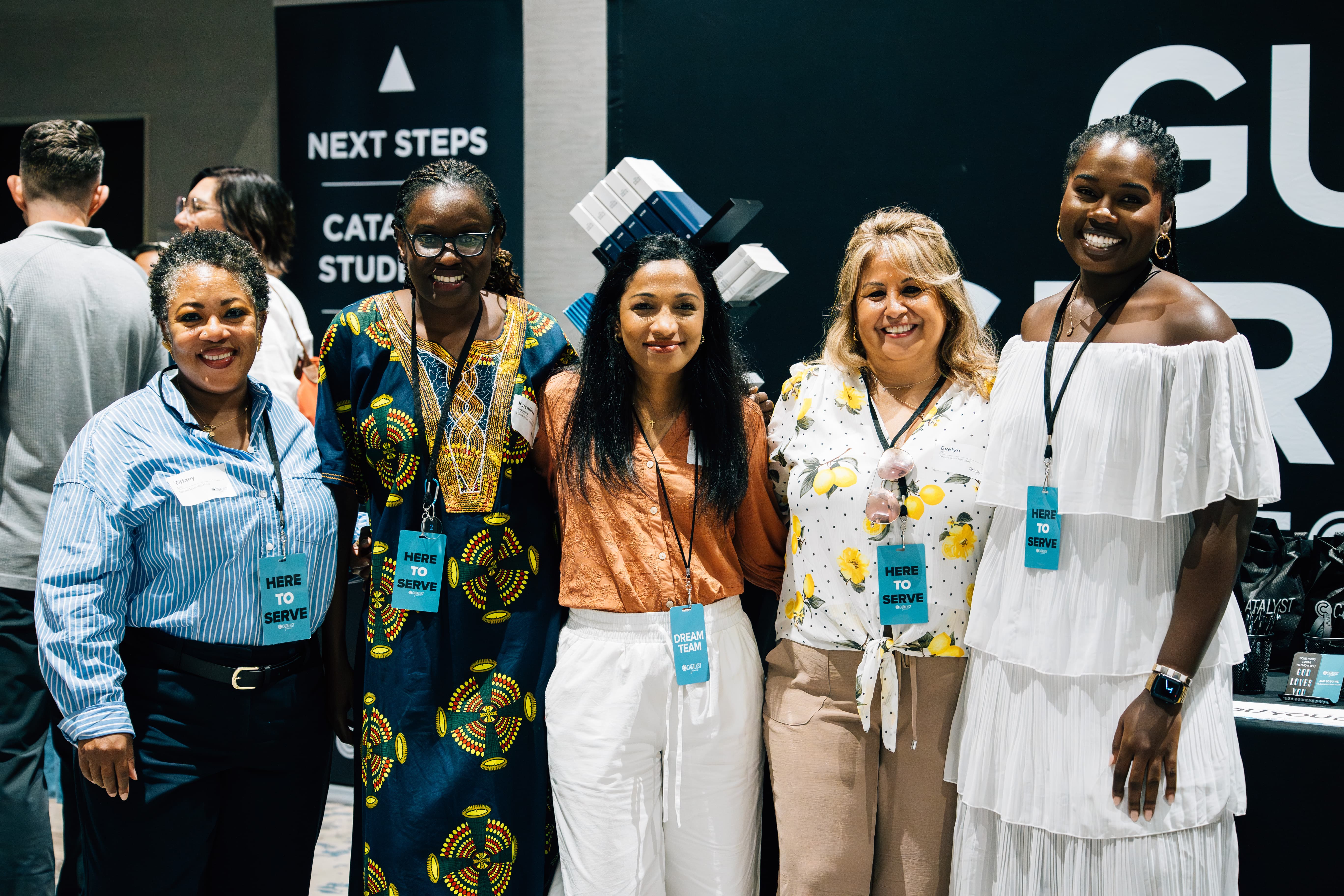 A photo of a young women from catalyst holding a welcome sign