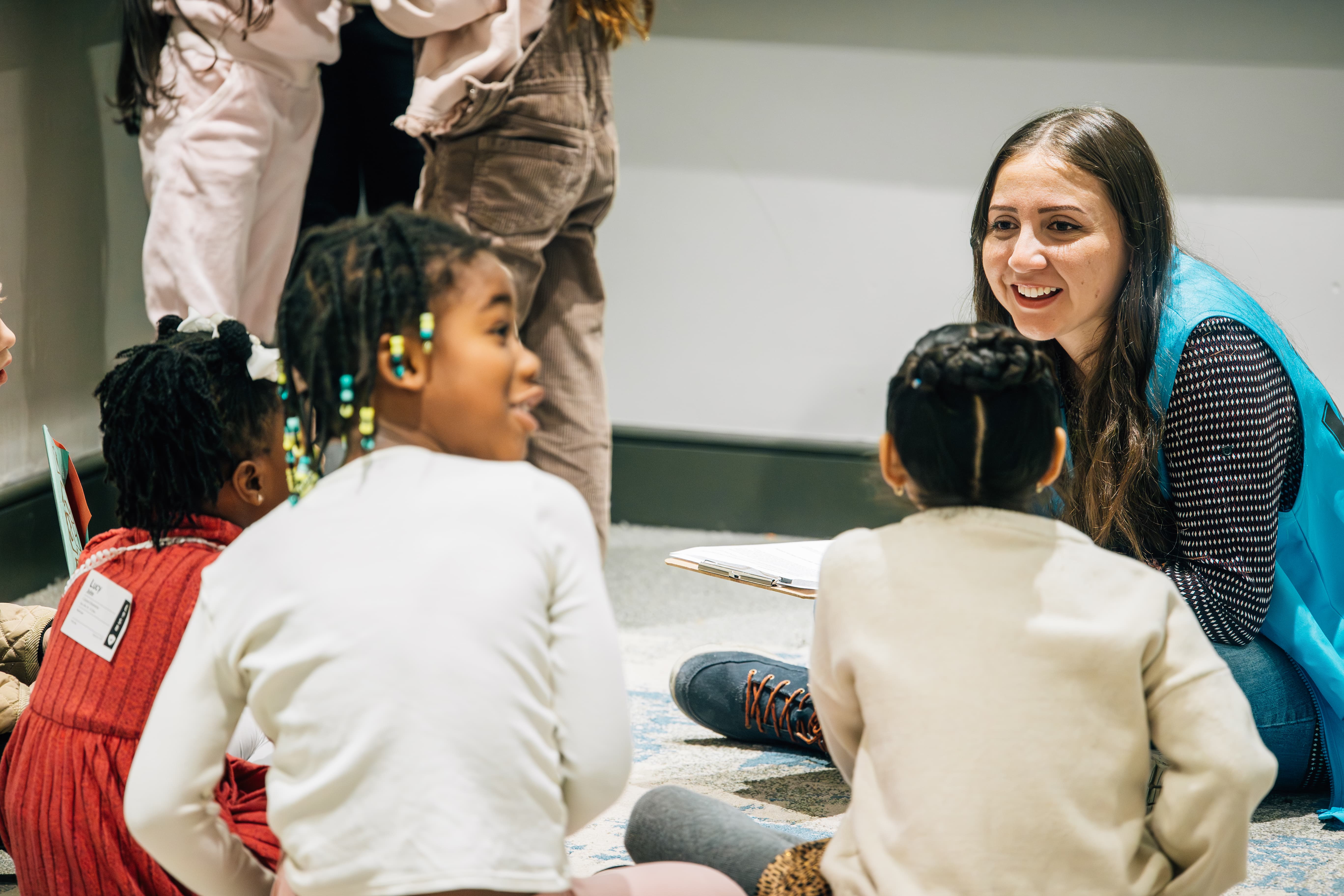 a photo of kids sitting at a table coloring.