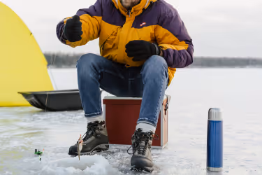Person pulling a fish from the frozen lake