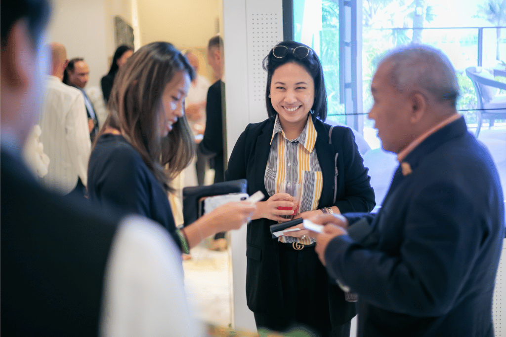 smiling event attendee standing with two other attendees