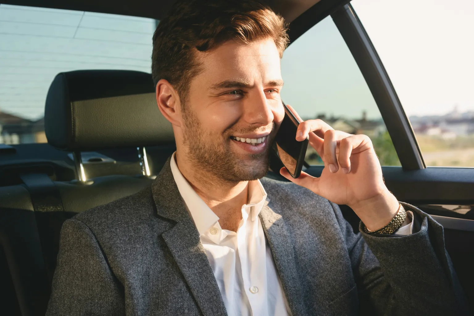 business man talking on a business phone in a car