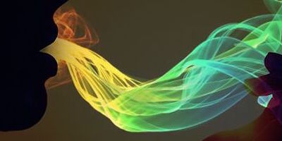 A vector image of colored waves being breathed out of a black silhouetted face.