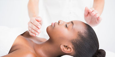 hands hovering over a woman's head and chest