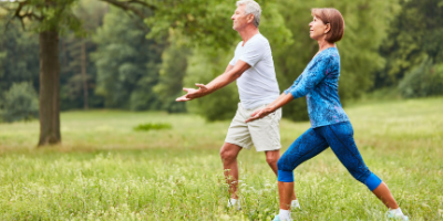 man practicing qi gong in forest on rock in creek