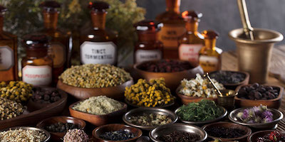 healing herbs and spices in bowls and jars