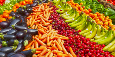 vegetables and fruit on table with glass of water