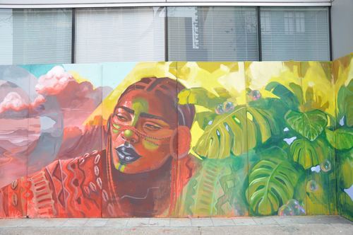 Racial justice mural on side of boarded up building