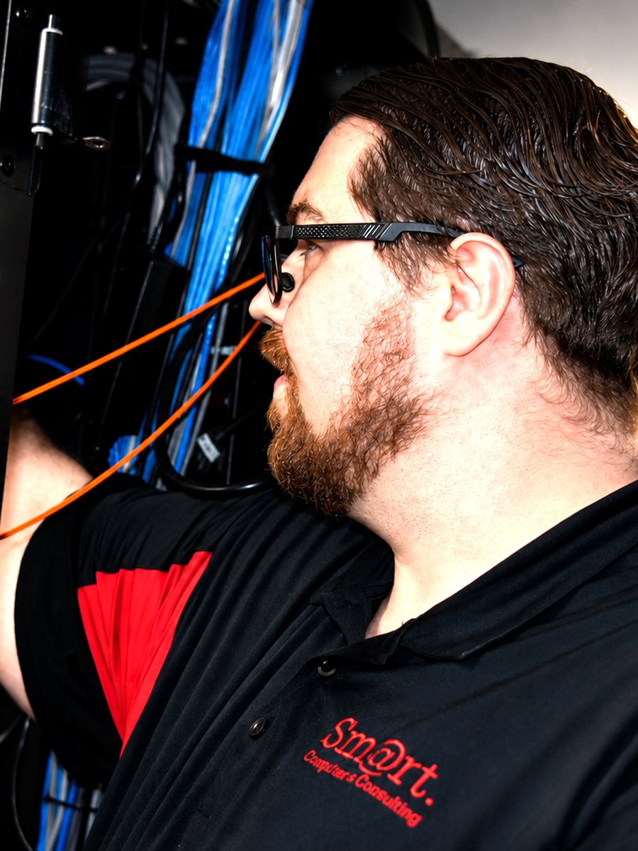 Smart Computers engineer working on structured network cabling inside a server rack in Dickinson, North Dakota