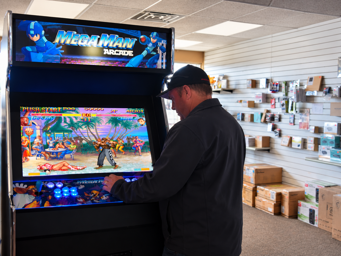 A Smart Computers team member at an arcade cabinet in the Dickinson, North Dakota showroom