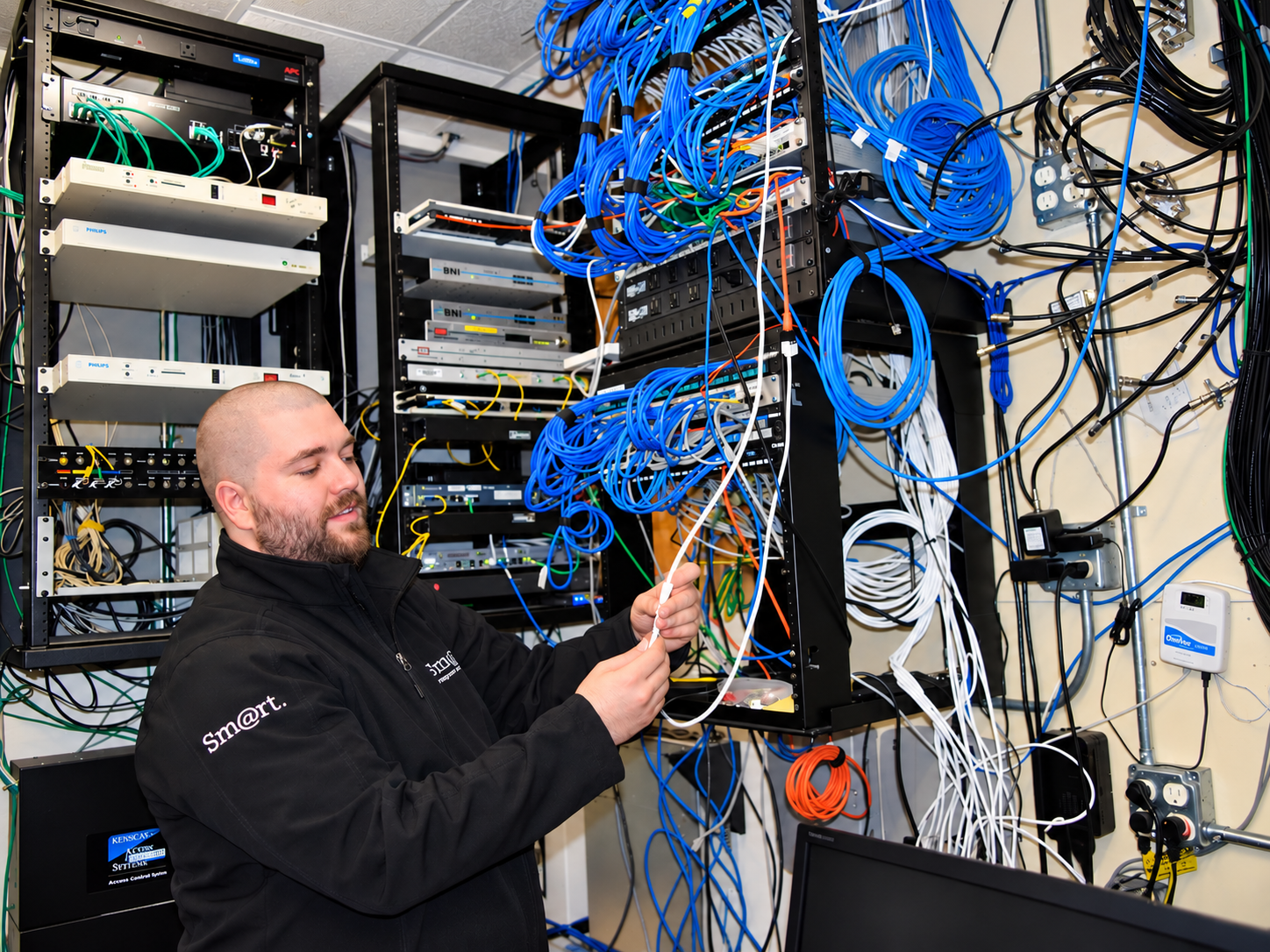Smart Computers technician working on server racks and network cabling in North Dakota
