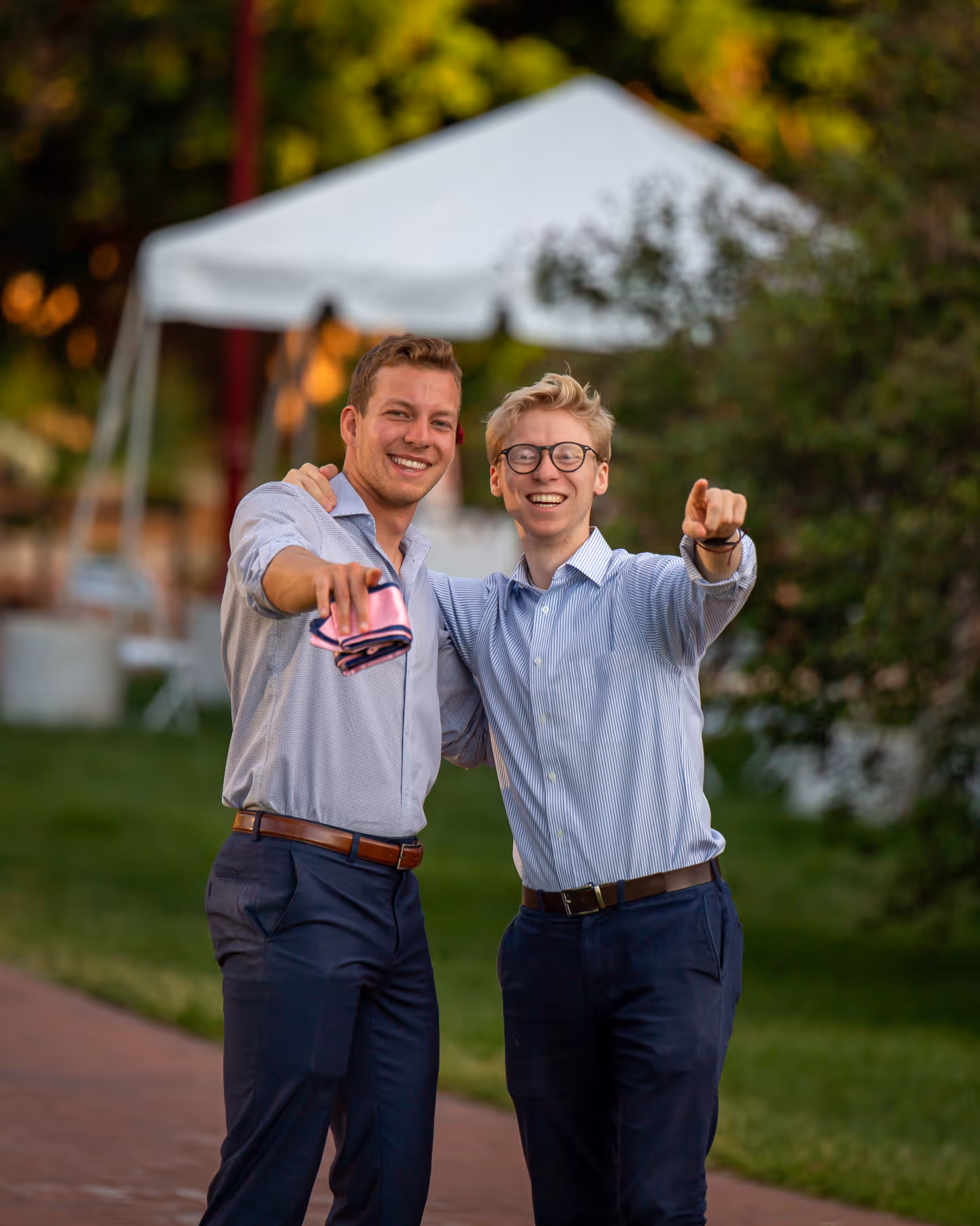 two guys with drinks raised