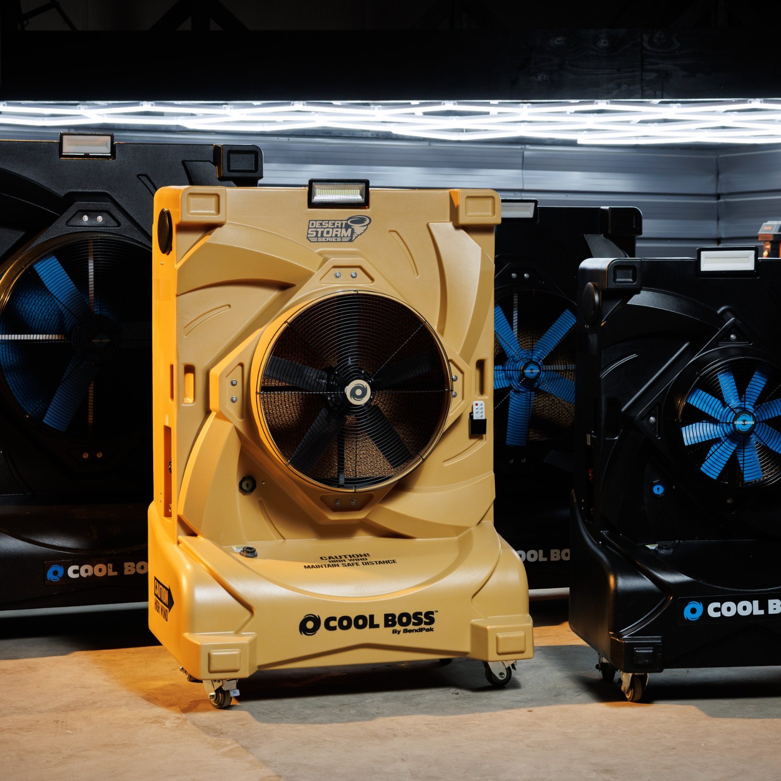Cool Boss lineup including the tan Desert Storm Series cooler in a garage