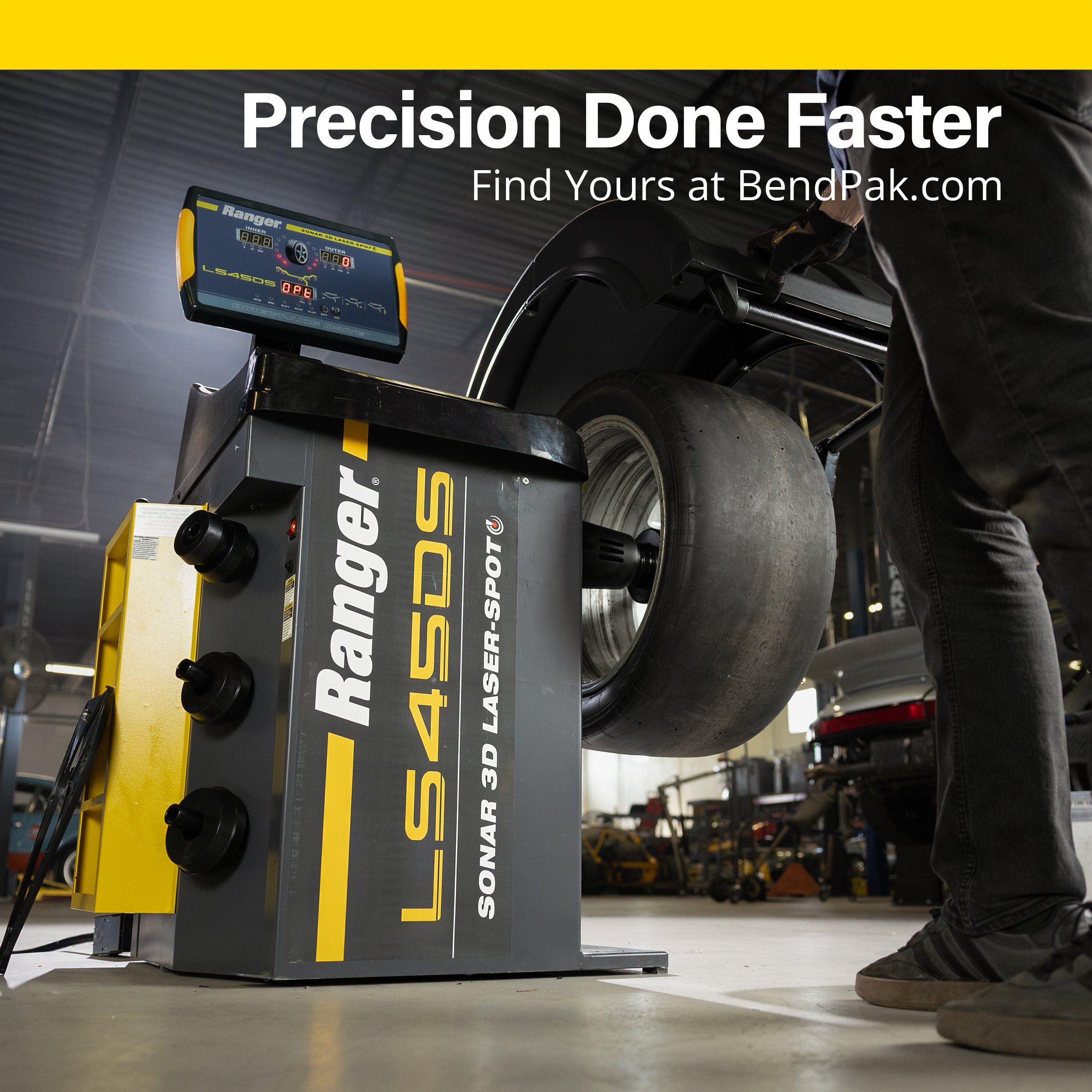 Technician mounting a race tire on the Ranger LS45DS balancer – "Precision Done Faster" ad