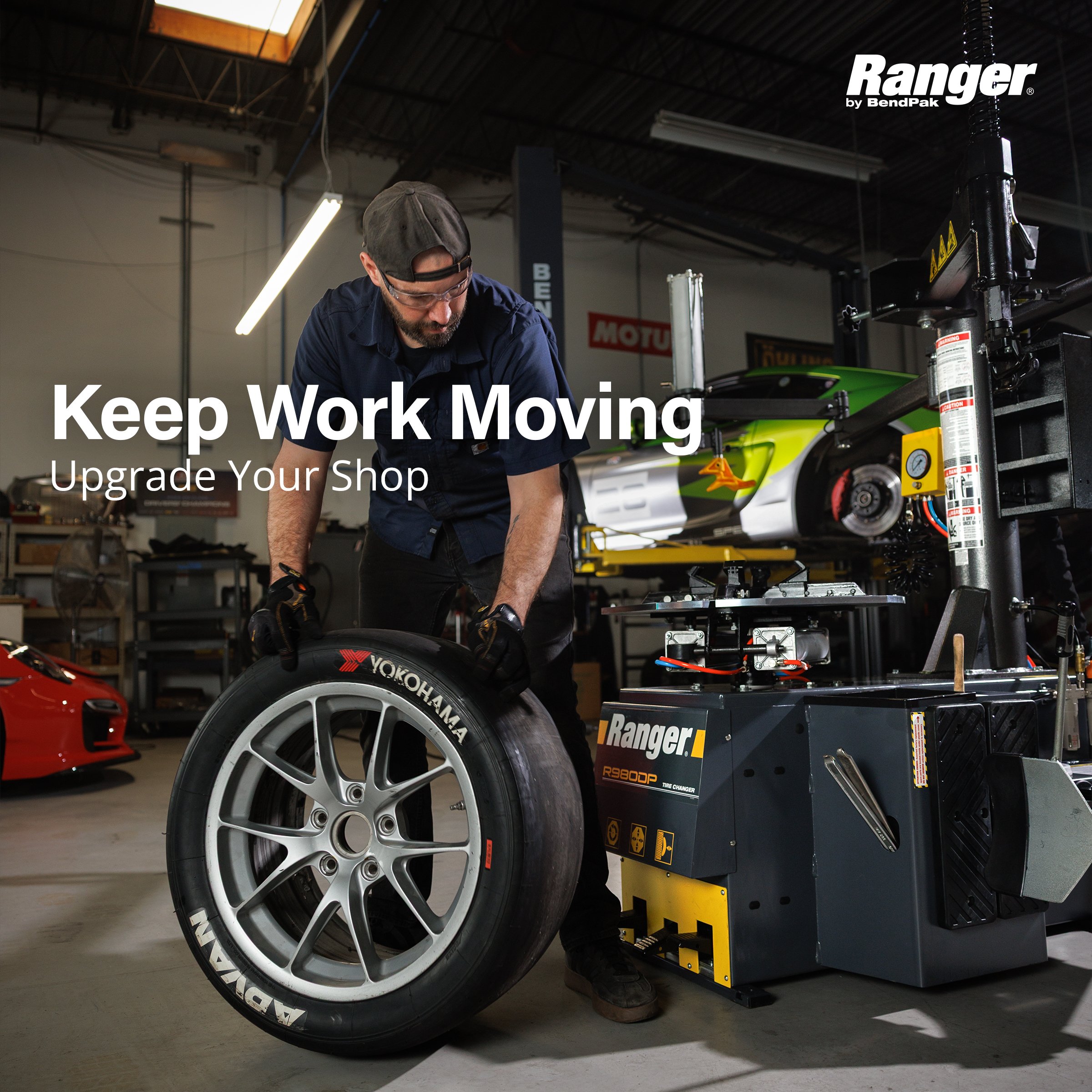 Technician rolling a Yokohama race tire to the Ranger R980DP tire changer – "Keep Work Moving" ad