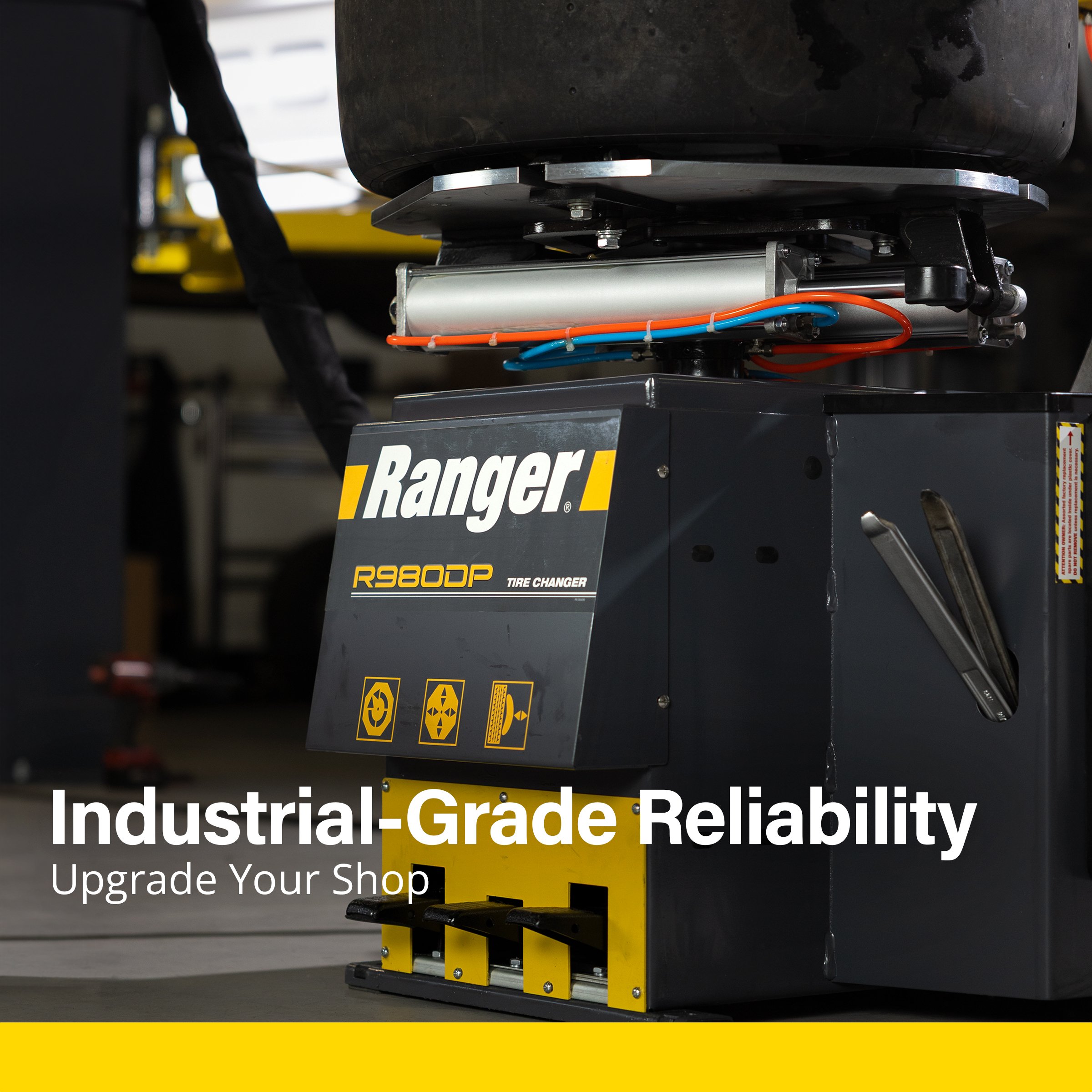 Close-up of the Ranger R980DP tire changer base – "Industrial-Grade Reliability" ad