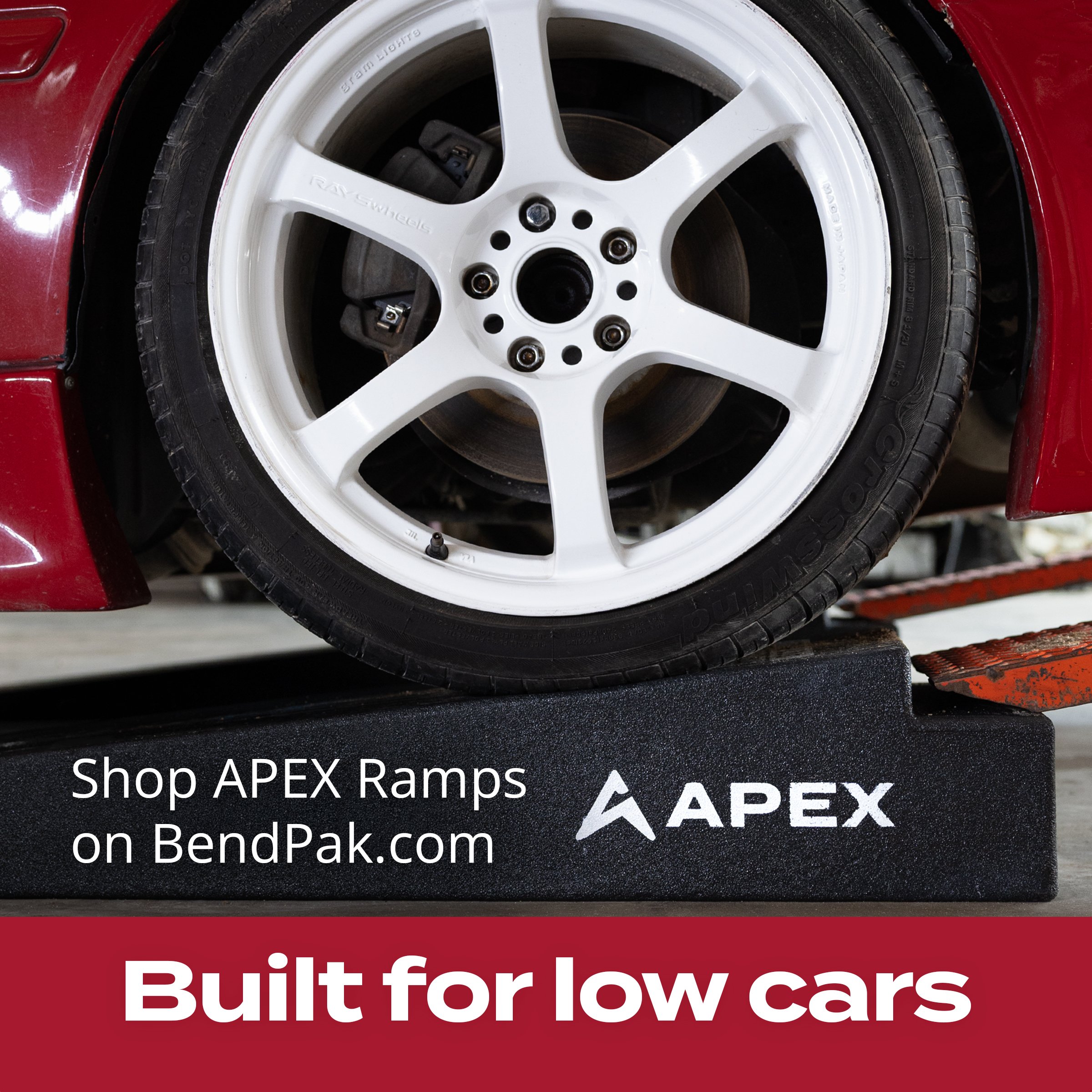 White wheel on a low red car resting on an APEX ramp – "Built for low cars" ad
