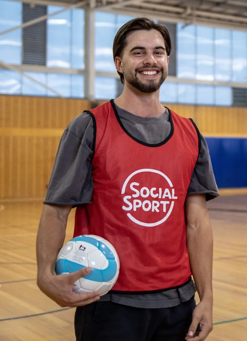 A male Futsal player holds a ball