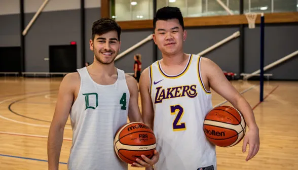 Two male social Basketball players stand next to each other