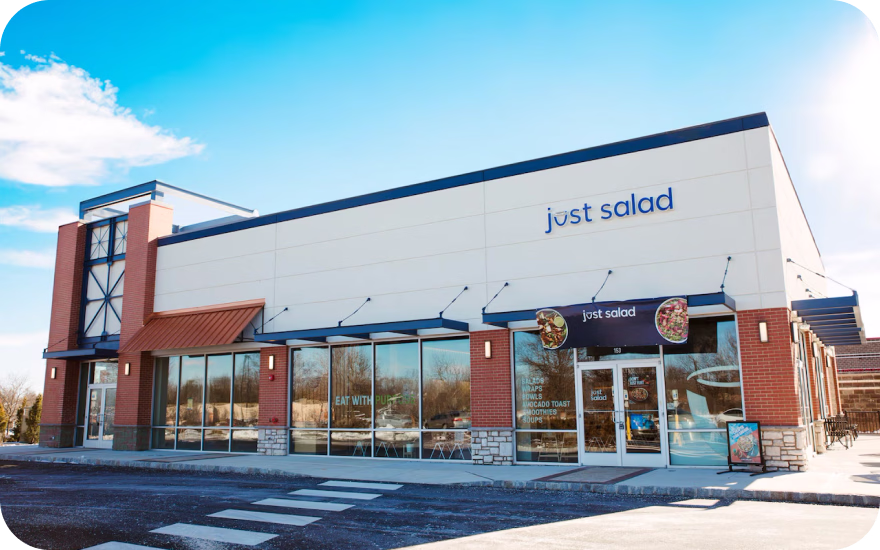 Just Salad fast-casual healthy restaurant exterior with logo and entrance.