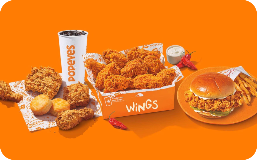 Popeyes Canada spicy fried chicken meal with seasoned sides and signature biscuit.