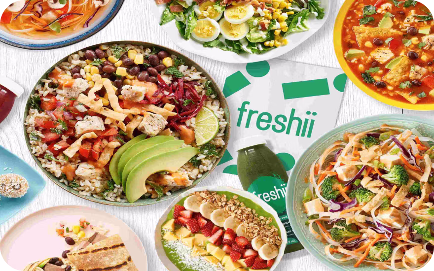 A table full of colorful salads and bowls from Freshii, a top Canadian franchise in 2026.