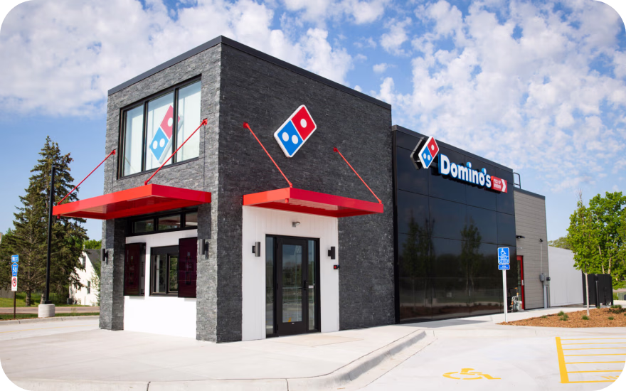 Domino’s Pizza storefront with blue-and-red branding, highlighting a top US delivery-focused franchise.