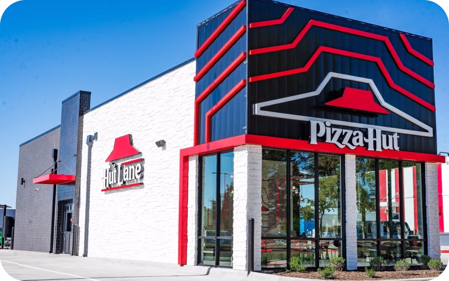 Pizza Hut storefront with classic red roof elements and updated signage from a top US pizza franchise.