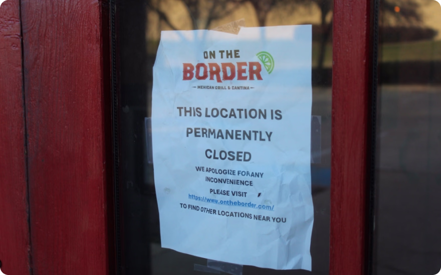 A crumpled piece of paper on a restaurant window that reads "On the Border; This Location is Permanently Closed"