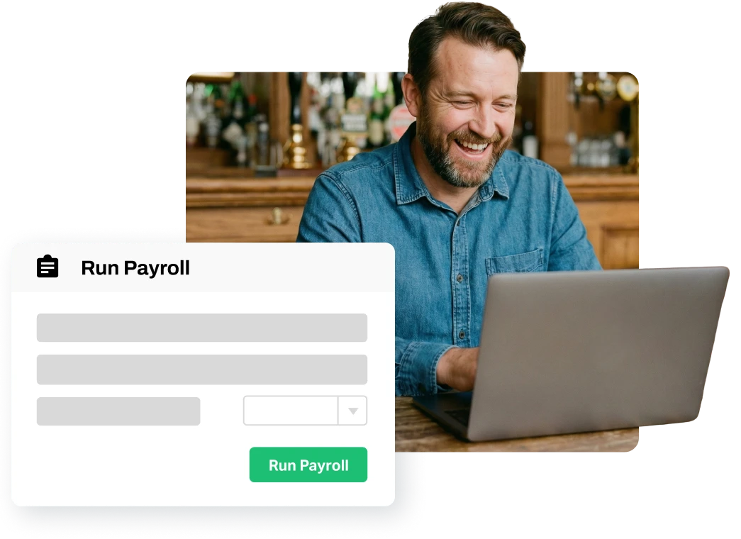 Smiling man using a laptop with a payroll software interface displaying a 'Run Payroll' button.