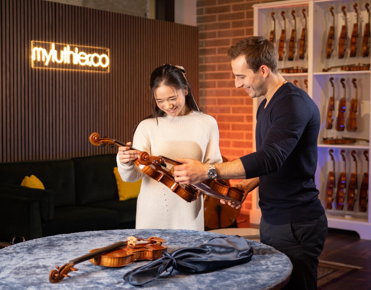 myluthier co-founder Ariel Lang with a violin client at the showroom