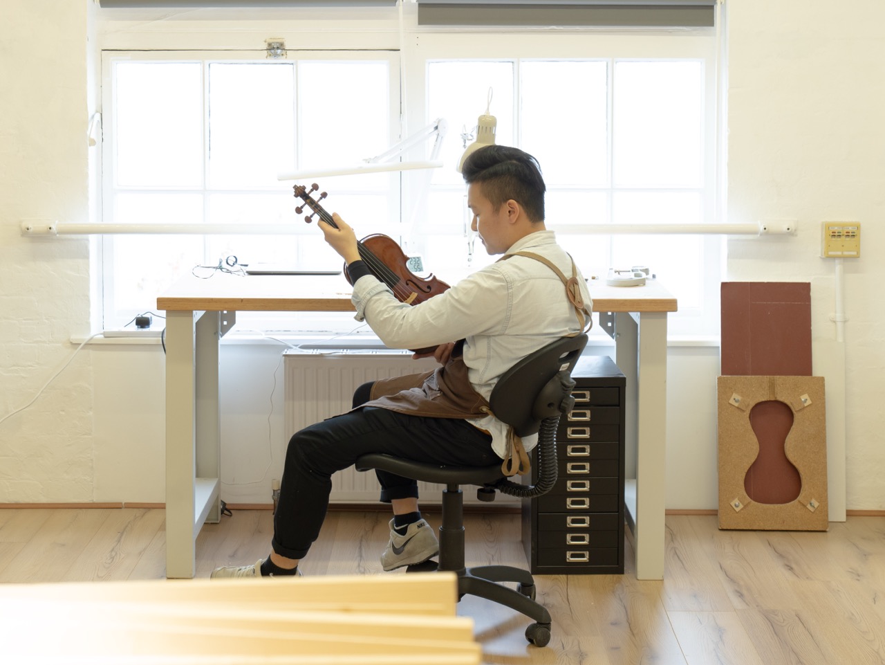 violin being assessed at the myluthier workshop