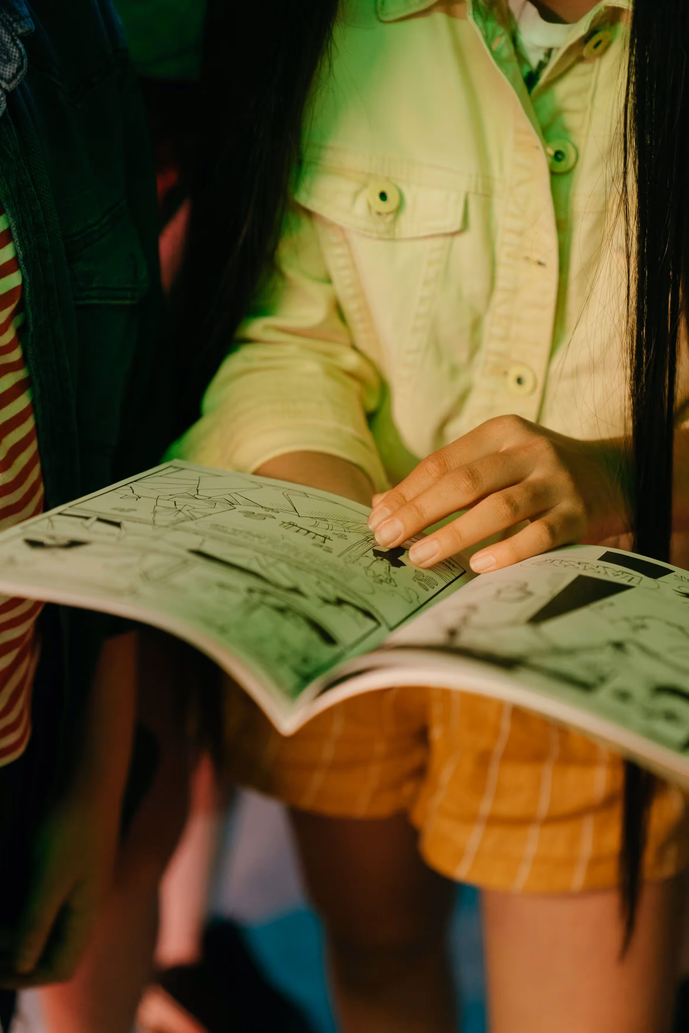a girl reading a comic in closeup